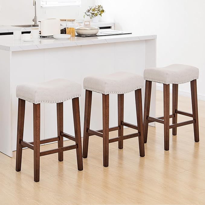PrimeZone Counter Height Bar Stools Set of 3 - Backless Saddle Barstools with 4.3" Thick Upholstered, Nailhead Trim Linen Fabric & Solid Wood Legs, 26 Inch Counter Stools for Kitchen Island, Beige
